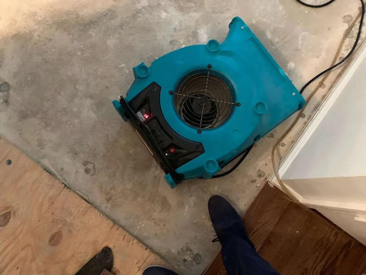 Air mover drying subfloor during Commercial Water Damage Restoration in Fort Scott